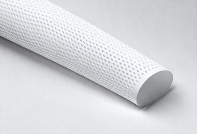 The primary subject of the image is a white, patterned object, which appears to be a pillow or a piece of furniture. The setting is a white background, which provides a clean and minimalist appearance. The visual style is a close-up of the object, showcasing its texture and pattern. The colors and mood of the image are predominantly white, giving it a clean and simple appearance.
