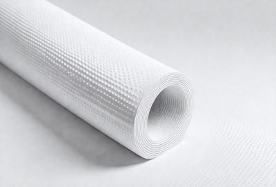 The primary subject of the image is a roll of white paper, which is the main object in the scene. The paper is sitting on a white surface, which serves as the background. The visual style of the image is a photo, capturing the details of the paper roll. The colors in the image are predominantly white, giving it a clean and simple appearance. The overall mood of the image is calm and uncluttered.