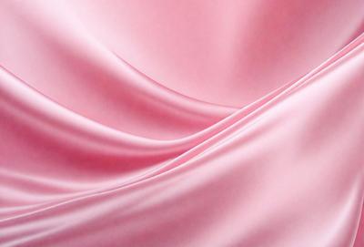 The primary subject of the image is a pink fabric, which is the main object, scene, or focus of the image. The setting/background consists of a pink background, which complements the pink fabric. The visual style of the image is a close-up of the pink fabric, showcasing its texture and details. The colors and mood of the image are predominantly pink, creating a warm and inviting atmosphere.