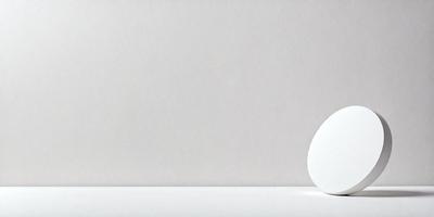 The primary subject of the image is a white egg, which is placed on a white surface. The setting is a white wall, and the visual style appears to be a photo. The colors and mood of the image are predominantly white, giving it a clean and minimalist appearance.