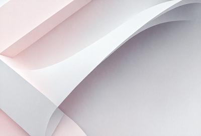 The primary subject of the image is a white sheet of paper with a pink border. The setting is a room with a wall, and the visual style is a close-up of the paper. The colors and mood of the image are predominantly white and pink, creating a calm and serene atmosphere.