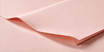 The primary subject of the image is a pink sheet of paper. The setting is a room with a pink background. The visual style is a close-up of the paper, showcasing its texture and color. The colors and mood of the image are predominantly pink, creating a warm and inviting atmosphere.