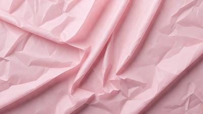 The primary subject of the image is a pink sheet of paper. The setting is a pink background, which creates a warm and inviting atmosphere. The visual style is a close-up of the pink paper, showcasing its texture and color. The colors and mood of the image are predominantly pink, giving it a soft and delicate appearance.