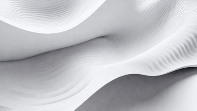 The primary subject of the image is a white sheet of paper with a pattern of waves. The setting is a gray background, which contrasts with the white paper. The visual style is a close-up of the paper, showcasing the intricate pattern of waves. The colors and mood of the image are predominantly white, giving it a clean and minimalist appearance.