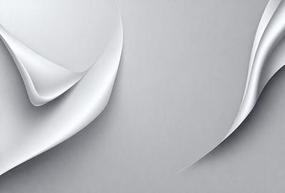 The primary subject of the image is a white sheet of paper. The setting is a gray background, which creates a contrast with the white paper. The visual style is a close-up of the paper, showcasing its texture and details. The colors and mood of the image are predominantly neutral, with the white paper and gray background creating a calm and clean atmosphere.