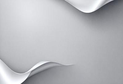 The primary subject of the image is a white sheet of paper. The setting is a gray background, which creates a contrast with the white paper. The visual style is a close-up of the paper, showcasing its texture and details. The colors and mood of the image are predominantly neutral, with the white paper and gray background creating a calm and clean atmosphere.