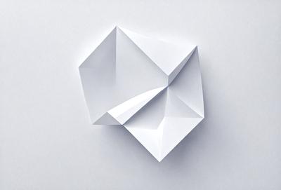 The primary subject of the image is a white paper, which is the main object, scene, or focus of the image. The setting is a white background, and the visual style is a photo. The colors and mood of the image are predominantly white, giving it a clean and minimalist appearance.