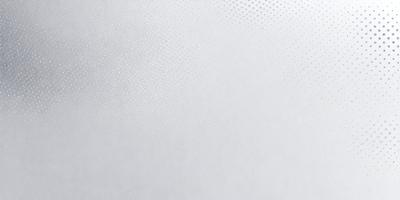 The primary subject of the image is a white wall with a pattern of small holes. The setting is a room with a white background. The visual style is a close-up of the wall, showcasing the pattern of the holes. The colors and mood of the image are predominantly white, giving it a clean and minimalist appearance.
