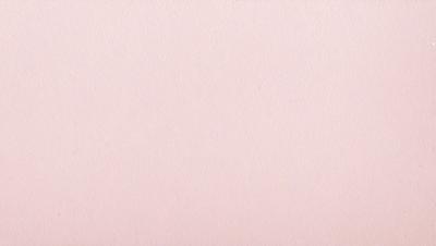 The primary subject of the image is a large sheet of pink paper. The setting is a blank, white background, which creates a clean and minimalist visual style. The colors and mood of the image are predominantly pink, giving it a warm and inviting atmosphere.