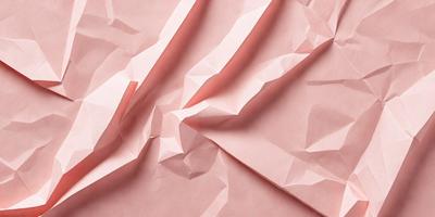The primary subject of the image is a pink sheet of paper with a pattern of folded edges. The setting is a room with a pink background, and the visual style is a close-up of the paper. The colors and mood of the image are predominantly pink, creating a warm and inviting atmosphere.