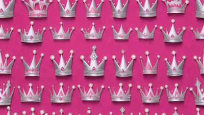 The primary subject of the image is a collection of pink and silver crown-shaped decorations. These decorations are arranged in a pattern, covering a pink background. The visual style of the image is a combination of digital art and illustration, creating a unique and eye-catching design. The colors and mood of the image are predominantly pink and silver, giving it a feminine and elegant appearance.