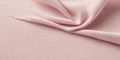 The primary subject of the image is a pink fabric, which is the main object, scene, or focus of the image. The setting or background is a white surface, and the visual style is a photo. The colors and mood of the image are predominantly pink, creating a warm and inviting atmosphere.