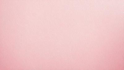 The primary subject of the image is a pink background. The setting is a blank, untouched surface, which gives the impression of a clean and unused space. The visual style is a close-up of the pink background, showcasing its color and texture. The colors and mood of the image are predominantly pink, creating a warm and inviting atmosphere.