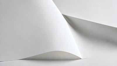The primary subject of the image is a white piece of paper. The paper is folded in a way that it appears to be a triangle. The setting is a white background, which provides a clean and minimalistic appearance. The visual style is a simple, flat image with no additional elements or textures. The colors and mood of the image are predominantly white, giving it a clean and uncluttered feel.