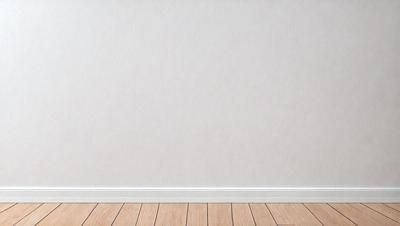 The primary subject of the image is a white wall with a wooden floor. The setting is a room with a white wall, and the visual style is a photo. The colors and mood of the image are predominantly white, creating a clean and minimalist atmosphere.