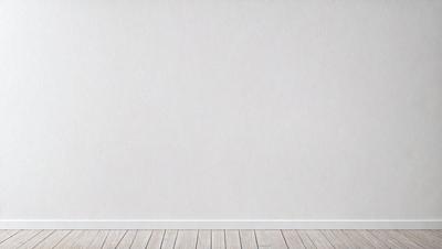 The primary subject of the image is a white wall with a wooden floor. The setting is a room with a blank wall, and the visual style is a photo. The colors and mood of the image are predominantly white, giving it a clean and minimalist appearance.
