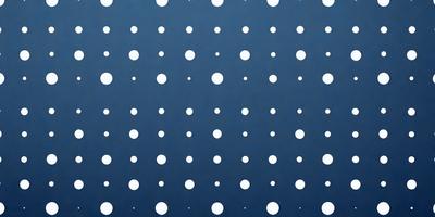 The primary subject of the image is a blue background with a pattern of white dots. The setting appears to be a wall or a surface with a blue color. The visual style of the image is a pattern or a texture, which gives it a unique and artistic appearance. The dominant colors in the image are blue and white, creating a calm and soothing atmosphere.