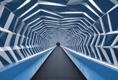 The primary subject of the image is a long, narrow tunnel with a blue light illuminating it. The tunnel appears to be made of glass, giving it a modern and sleek appearance. The setting is an underground passage, likely in a city or urban area. The visual style of the image is a combination of photo and digital art, creating a unique and captivating atmosphere. The dominant colors in the image are blue and white, which contribute to the overall mood of the scene.
