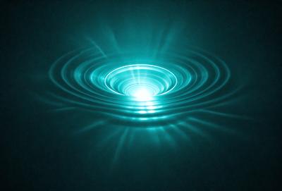 The primary subject of the image is a blue, glowing, circular wave in the ocean. The wave appears to be a vortex, with a bright light shining through it. The setting is the ocean, with the wave being the main focus of the image. The visual style is a photo, capturing the vibrant colors and unique formation of the wave. The colors and mood of the image are predominantly blue and serene, creating a sense of calmness and beauty.