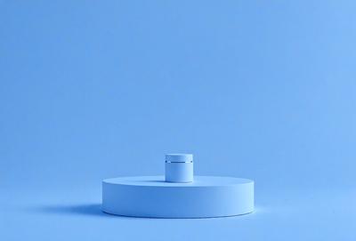 The primary subject of the image is a white object, possibly a small white table or a white bowl, placed on a blue surface. The setting appears to be a room with a blue wall, and the visual style is a close-up of the white object on the blue surface. The colors and mood of the image are predominantly blue and calm, creating a serene atmosphere.