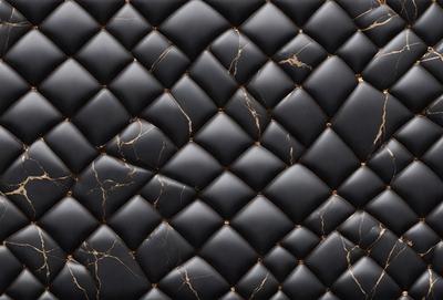 The primary subject of the image is a black and gold patterned couch. The setting is a room with a black and gold patterned wall, which complements the couch. The visual style is a close-up of the couch, showcasing its intricate design. The colors and mood of the image are predominantly black and gold, creating a luxurious and elegant atmosphere.