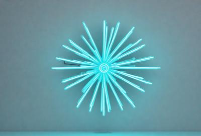 The primary subject of the image is a large, blue neon light display that resembles a flower. The setting is a white wall, and the visual style is a digital art or illustration. The dominant colors are blue and white, creating a calm and serene atmosphere.