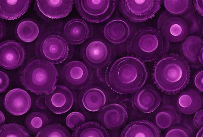 The primary subject of the image is a close-up of a purple bottle cap. The setting is a purple background, which creates a visually striking contrast with the cap. The visual style is a close-up of the cap, emphasizing its details. The colors and mood of the image are predominantly purple, giving it a unique and artistic appearance.