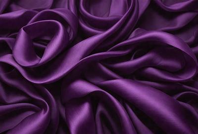 Purple fabric, possibly silk, with a flowing pattern.