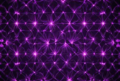 The primary subject of the image is a purple background with a pattern of purple stars. The setting is a dark background, which contrasts with the bright purple stars. The visual style is a digital art or illustration, as the purple stars are the main focus of the image. The colors and mood are predominantly purple, creating a calm and serene atmosphere.