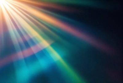 The primary subject of the image is a colorful light display, which appears to be a rainbow-colored light show. The setting is a dark background, which contrasts with the vibrant colors of the light display. The visual style of the image is a combination of photo and digital art, creating a unique and eye-catching effect. The colors and mood of the image are predominantly bright and cheerful, with the light display creating a sense of excitement and wonder.