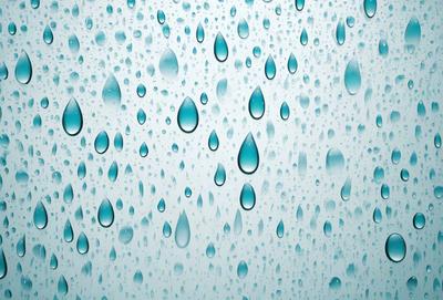 The primary subject of the image is a large, clear glass window with a blue tint. The window is filled with water droplets, creating a visually appealing and serene scene. The setting is indoors, likely in a room with a blue-tinted glass window. The visual style of the image is a close-up of the window, showcasing the water droplets and the blue tint. The colors and mood of the image are predominantly blue, creating a calm and soothing