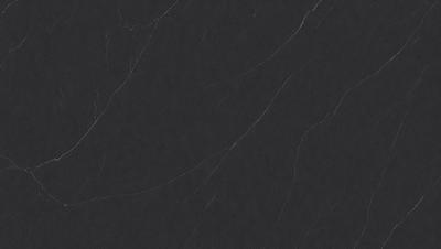 The primary subject of the image is a close-up of a black marble countertop. The setting is a kitchen, with the marble countertop being the main focus of the scene. The visual style is a photo, capturing the details and texture of the marble surface. The colors and mood of the image are predominantly dark, with the black marble providing a sleek and sophisticated appearance.