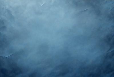 The primary subject of the image is a cloudy blue sky. The setting is a vast expanse of the sky, with no visible land or other objects. The visual style is a natural, outdoor scene. The colors and mood are predominantly blue, with a slightly overcast and moody atmosphere.