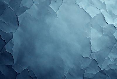 The primary subject of the image is a blue background with a pattern of peeling paint. The setting is a wall with a blue color, and the visual style is a close-up of the blue wall with peeling paint. The colors and mood of the image are predominantly blue, with a slightly distressed or aged appearance due to the peeling paint.