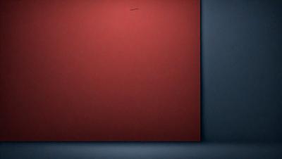 The primary subject of the image is a red square, which is the main object, scene, or focus of the image. The setting/background consists of a dark blue surface, which is the environment, backdrop, or surface visible in the image. The visual style of the image is a photo, as it is a real-life photograph of the red square. The dominant colors in the image are red and blue, creating a bold and striking atmosphere.