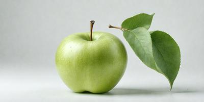 The primary subject of the image is a green apple, which is placed on a white surface. The apple is positioned in the center of the image, and it appears to be the main focus of the scene. The setting is minimalistic, with no background or additional objects visible. The visual style of the image is a close-up of the apple, emphasizing its texture and color. The overall atmosphere of the image is clean and simple, with the green apple being the main subject.