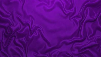Purple fabric with a pattern of swirls and waves.