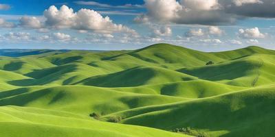 The image features a lush green hillside with a cloudy sky above. The landscape is a mix of grassy hills and a valley, creating a serene and picturesque scene. The primary subject is the vast expanse of greenery, which is the main focus of the image. The setting is a natural environment, with the sky serving as the backdrop. The visual style is a realistic representation of the landscape, capturing the beauty of the green hills and the valley below. The colors and mood of the image are pre
