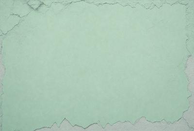 The primary subject of the image is a green background with a white border. The setting is a white surface, possibly a wall or a piece of paper. The visual style is a close-up of the green and white background, which gives the image a clean and minimalist appearance. The colors and mood of the image are predominantly green and white, creating a calm and serene atmosphere.
