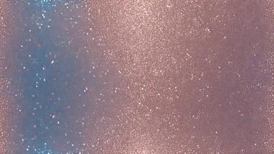 The primary subject of the image is a close-up of a pink and blue background with a pattern of stars. The setting is a dark background, and the visual style appears to be a combination of a photo and digital art. The dominant colors are pink and blue, creating a warm and inviting atmosphere.