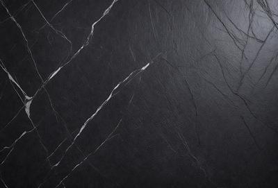 The primary subject of the image is a black marble wall with a leather-like texture. The setting is a dark room, and the visual style is a close-up of the marble wall. The colors and mood of the image are dark and moody, with the black marble and leather-like texture creating a dramatic and sophisticated atmosphere.
