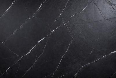 The primary subject of the image is a black marble countertop. The setting is a kitchen, with the countertop being the main focus of the scene. The visual style is a close-up of the marble countertop, showcasing its texture and details. The colors and mood of the image are dark and moody, with the black marble countertop being the dominant color.