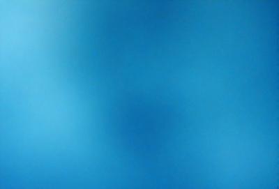 The primary subject of the image is a blue sky with a few clouds. The setting is a clear day with a cloudy blue sky. The visual style is a natural, outdoor scene. The colors and mood are predominantly blue, creating a calm and serene atmosphere.