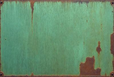 The primary subject of the image is a green metal surface with rust stains. The setting is an outdoor environment, possibly a metal surface in a park or a similar location. The visual style is a close-up of the metal surface, showcasing the rust stains and texture. The colors and mood of the image are predominantly green, with the rust stains adding a touch of brown and red.