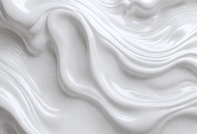 The primary subject of the image is a close-up of a white substance, which appears to be a creamy or frothy material. The setting is a white background, which provides a clean and uncluttered environment for the subject. The visual style of the image is a close-up, which emphasizes the texture and details of the white substance. The colors and mood of the image are predominantly white, giving it a clean and fresh appearance.