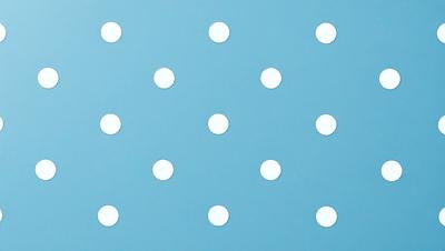 The primary subject of the image is a blue background with a pattern of white dots. The setting is a blue wall, and the visual style is a patterned background. The colors and mood of the image are predominantly blue and white, creating a calm and serene atmosphere.