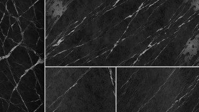 The primary subject of the image is a close-up of a marble countertop. The setting is a kitchen, with the countertop being the main focus of the scene. The visual style is a black and white photo, which adds a classic and timeless feel to the image. The dominant colors are black and white, creating a stark and elegant atmosphere.