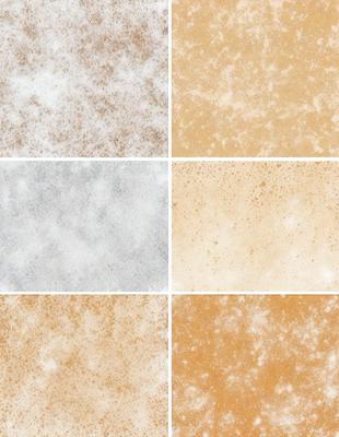 The image features a variety of textures and colors, showcasing different shades of brown and white. The primary subject is a collection of wallpaper samples, each with a distinct texture and design. The setting is a wall, and the visual style is a combination of photo and digital art. The colors and mood of the image are warm and inviting, with the brown tones creating a sense of comfort and familiarity.