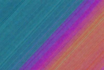 The primary subject of the image is a colorful striped pattern, which appears to be a digital art or illustration. The setting is a blue and purple background, creating a vibrant and lively atmosphere. The visual style is a mix of colors and patterns, with the striped pattern being the most prominent feature. The overall mood of the image is energetic and dynamic, with the bright colors and intricate patterns capturing the viewer's attention.