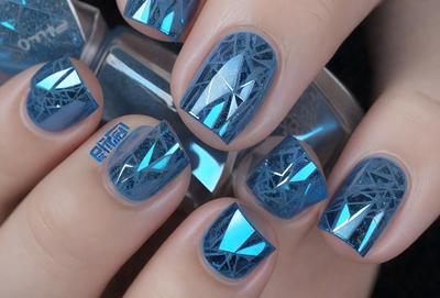 The primary subject of the image is a person's hand with blue nail polish on the fingernails. The setting is a room with a bottle of nail polish on a table. The visual style is a close-up of the person's hand with the nail polish. The colors and mood of the image are predominantly blue, creating a calm and soothing atmosphere.